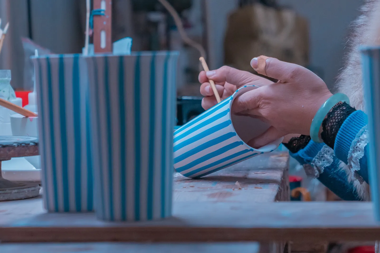 Striped Millie cups being painted in the workshop